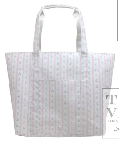TRVL XL JUMBO TOTE with luggage slide on suitcase